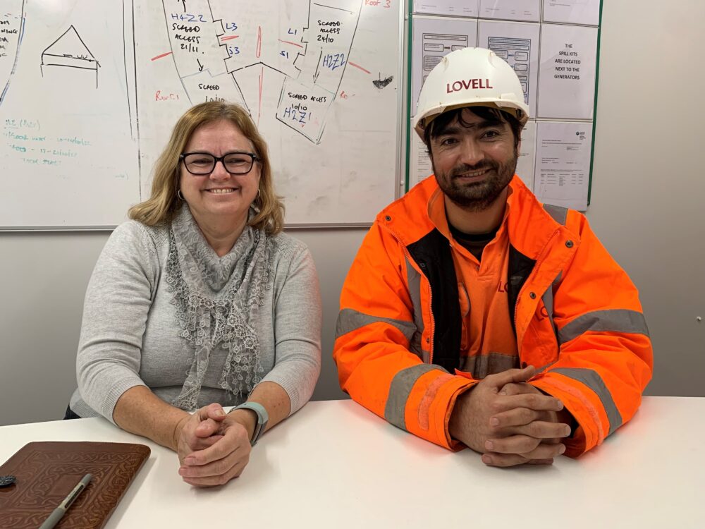 Hafizullah and Paula from Melin sitting next to each other in an office
