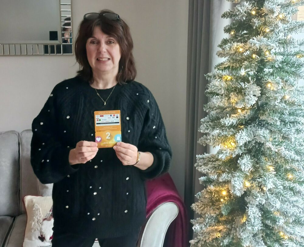 Voucher winner Judith holding her vouchers