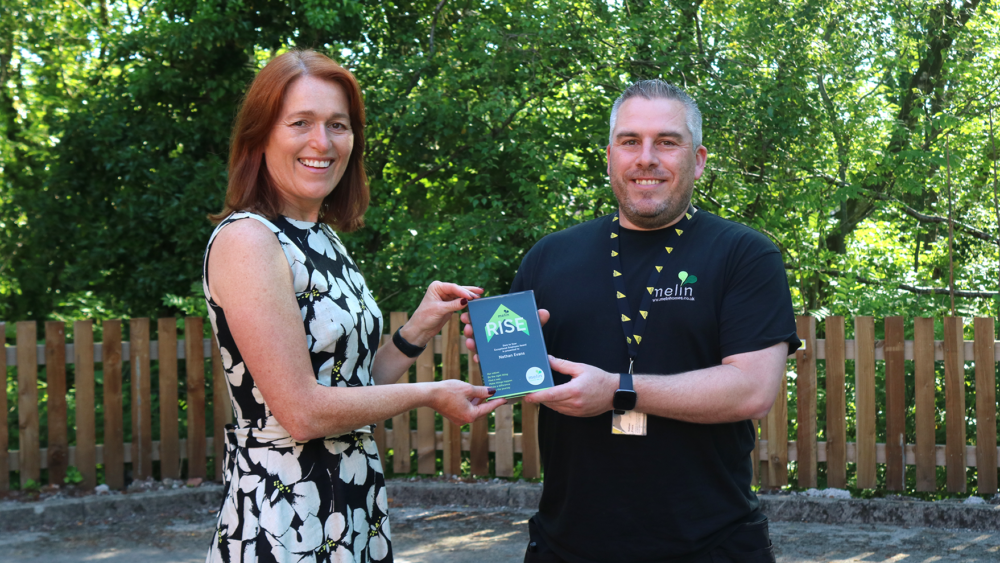 Melin Chief Exec, Paula Kennedy hand Nathan his award
