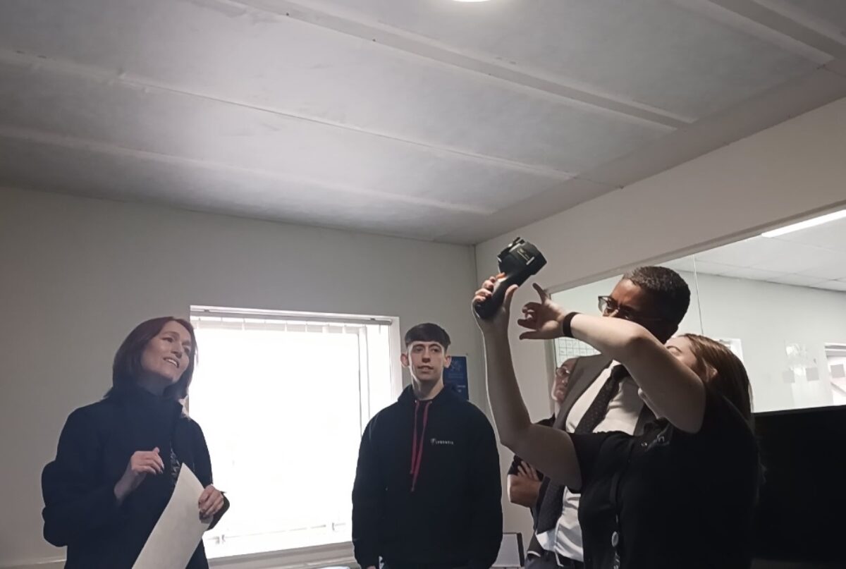 Katie shows the minister an innovative infrared heating product