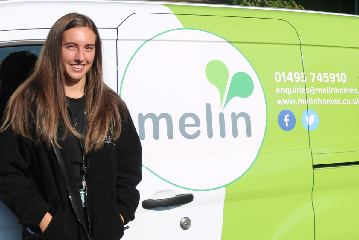 Emily standing by a Melin van
